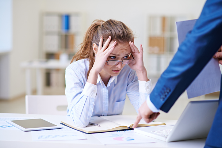 Woman looking stressed at desk